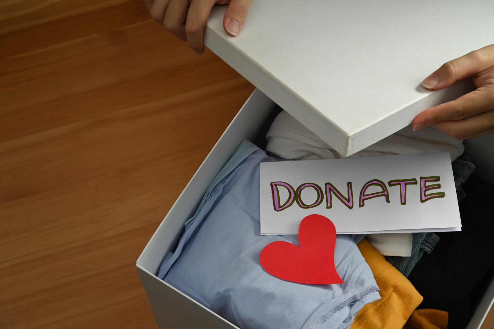 Woman preparing donate box for giving or charity activity. Donat